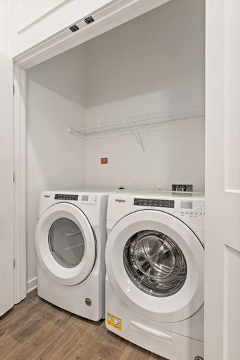 a washer and dryer in a laundry room  at The Griffin Royal Oak, Royal Oak, Michigan